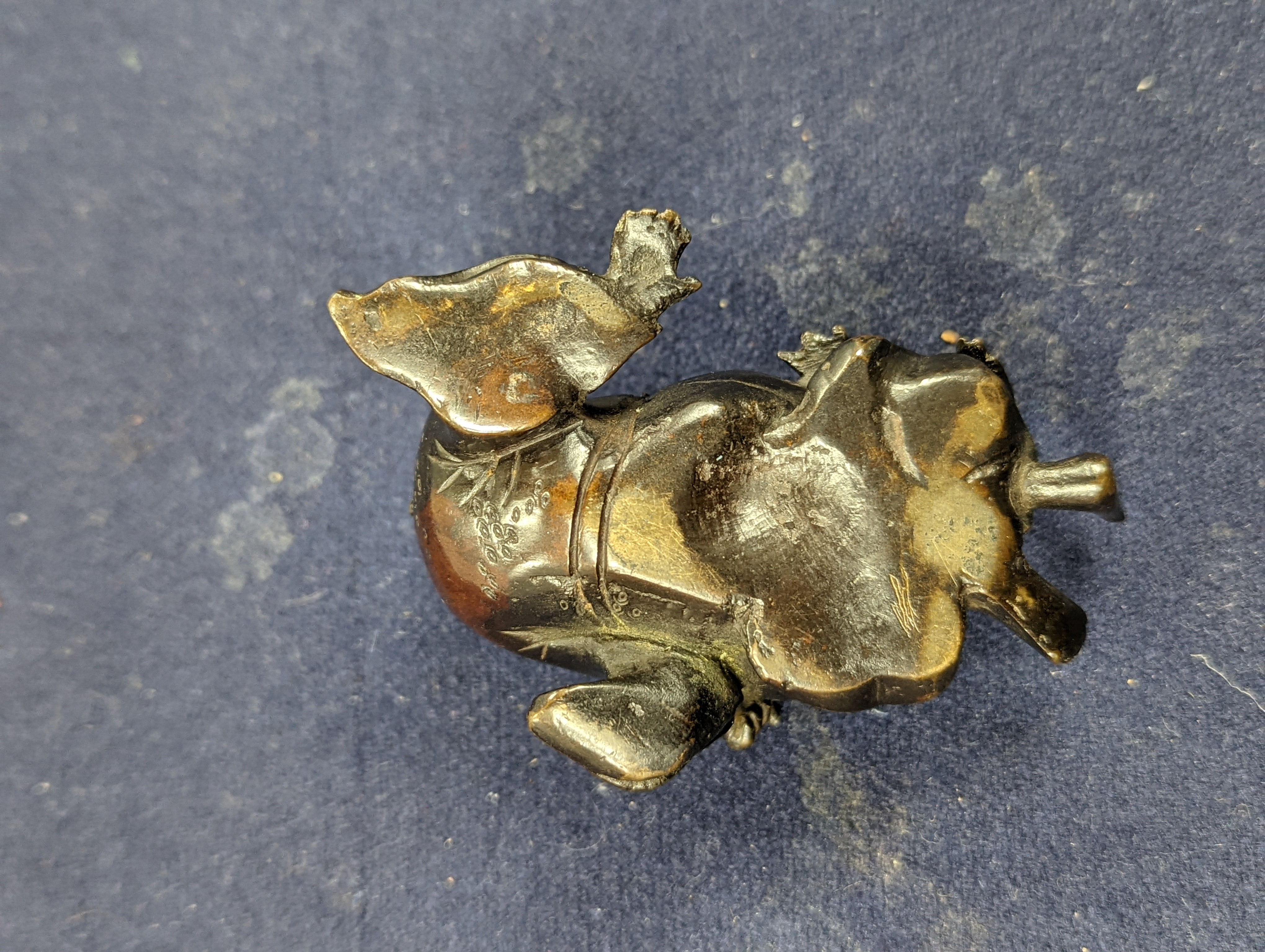 A Chinese bronze group of Liu Hai and a toad, wood stand and a bronze figure of a dog, 9cm